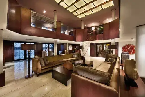 Elegant lounge aboard the M/S City & Sea Adonis with burgundy walls and modern furnishings.