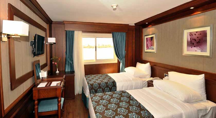 Deluxe cabin aboard the M/S City & Sea Adonis with twin beds and river view windows.