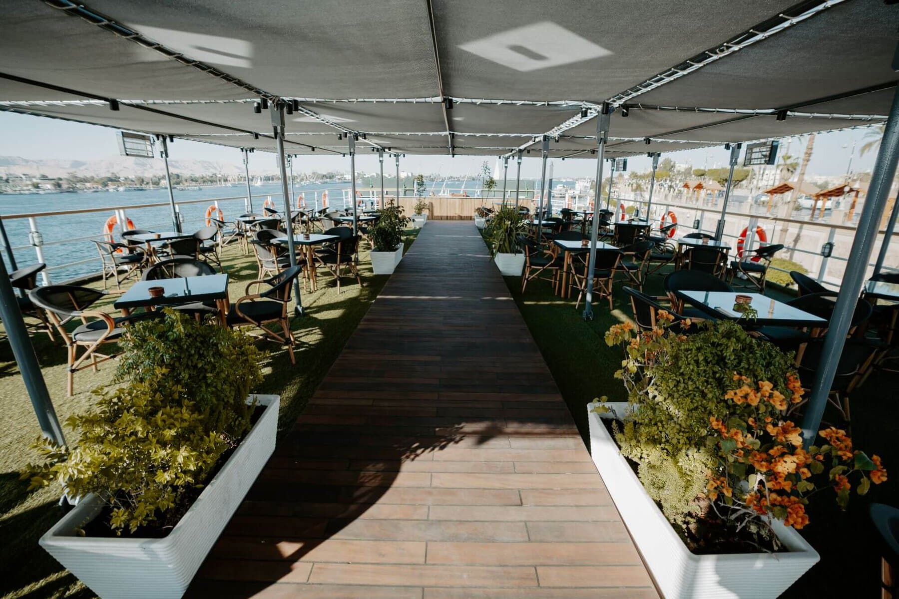 Shaded outdoor terrace with director chairs and Nile River views