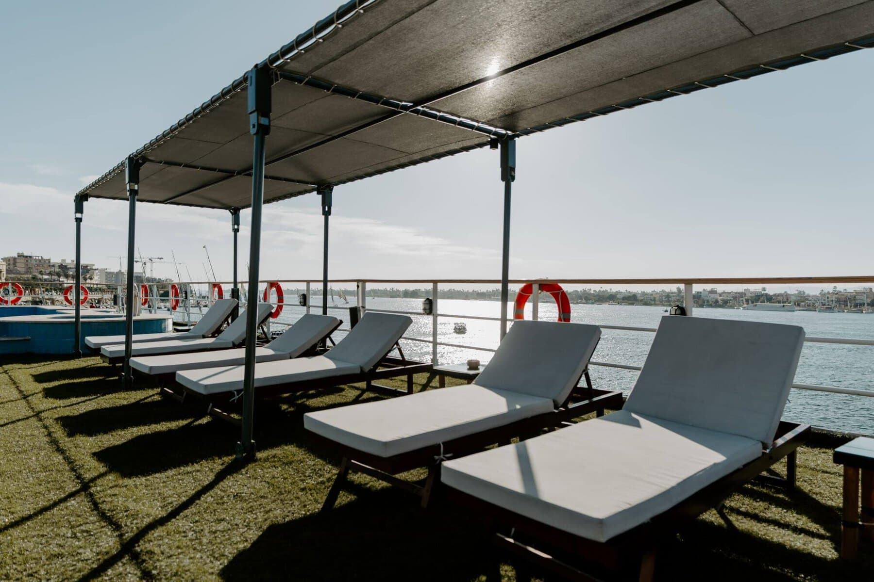 Sun deck with lounge chairs and canopy aboard the M/S City & Sea Adonis Nile cruise ship.