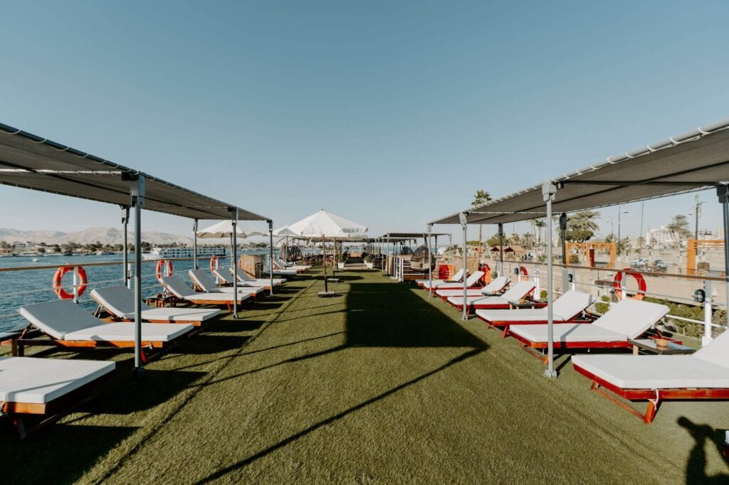 Sun deck aboard the M/S City & Sea Adonis with loungers, shade canopies and Nile River views.