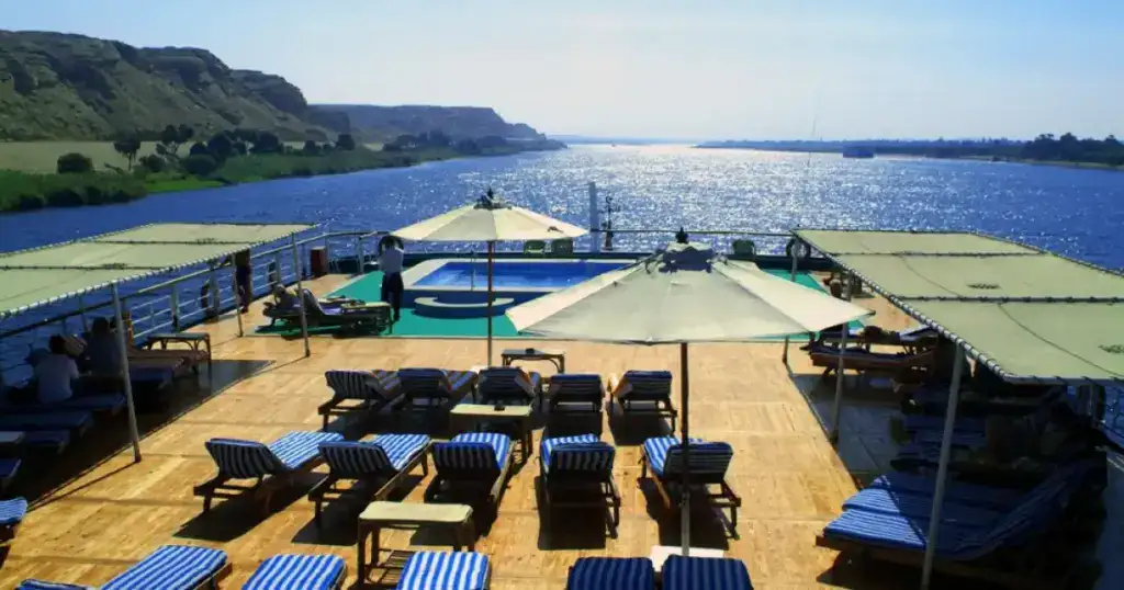 Sun deck aboard the M/S City & Sea Adonis with loungers, pool and Nile River views.