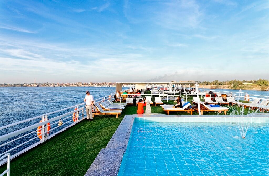 Pool and sun deck aboard the M/S City & Sea Adonis with Nile River views.