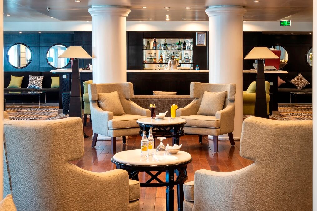 Elegant lounge aboard the M/S City & Sea Adonis with upholstered seating and bar.